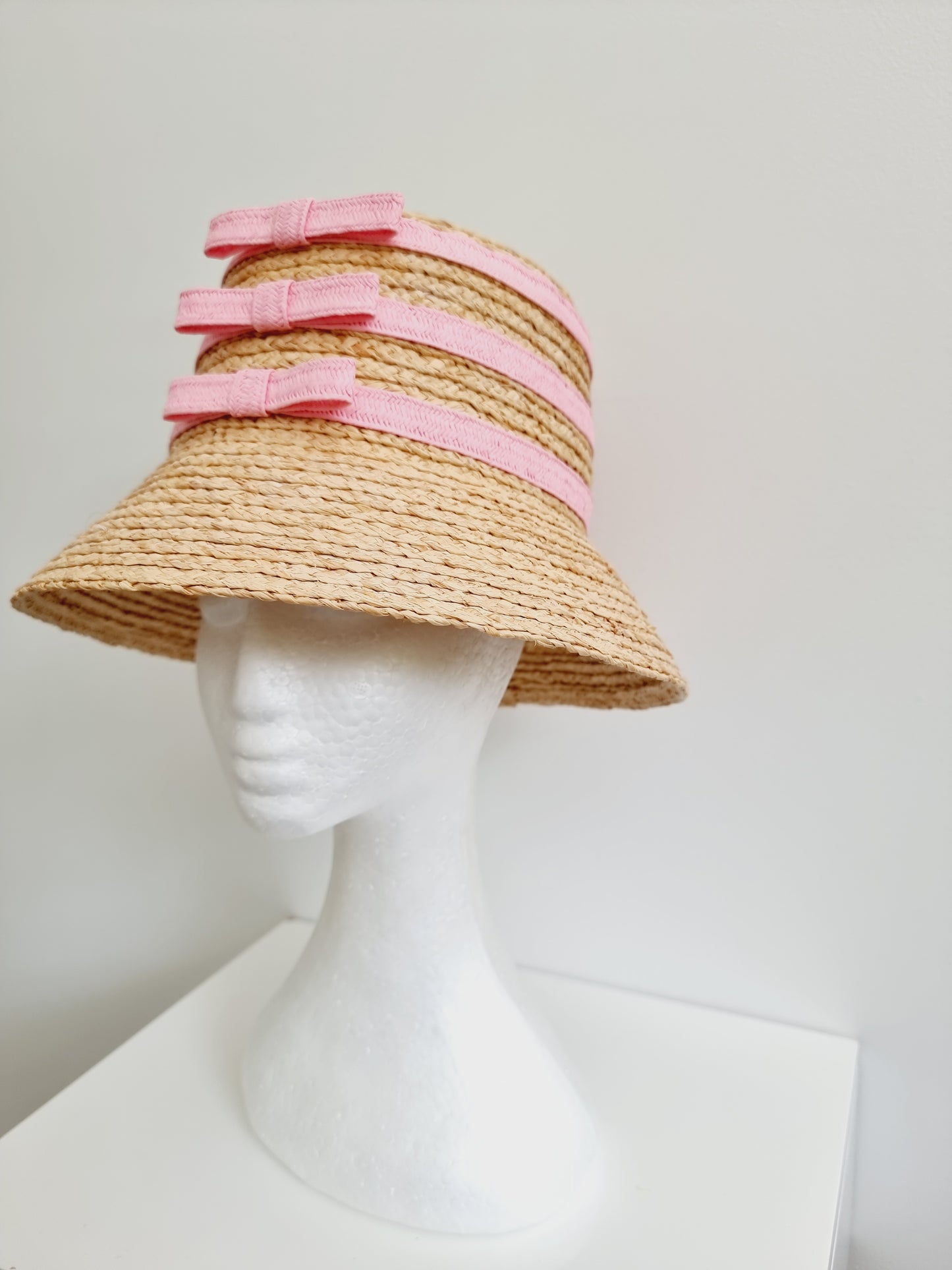 Miss Amara. Womens natural straw bucket hat with pink bow detail