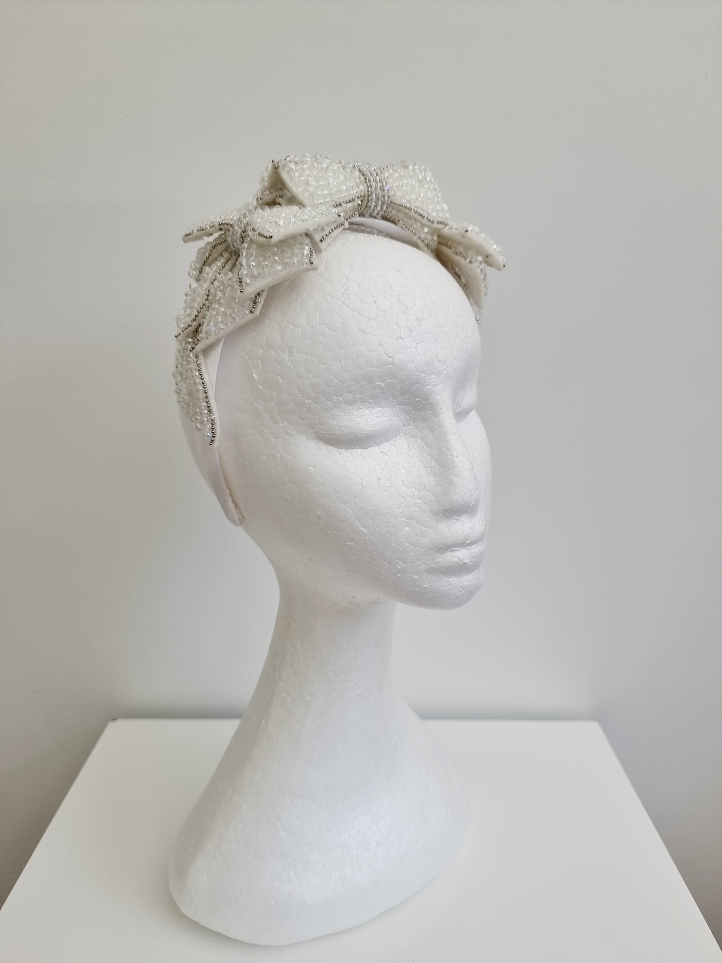 Miss Chateau. Womens off white crystal bow embellished headband