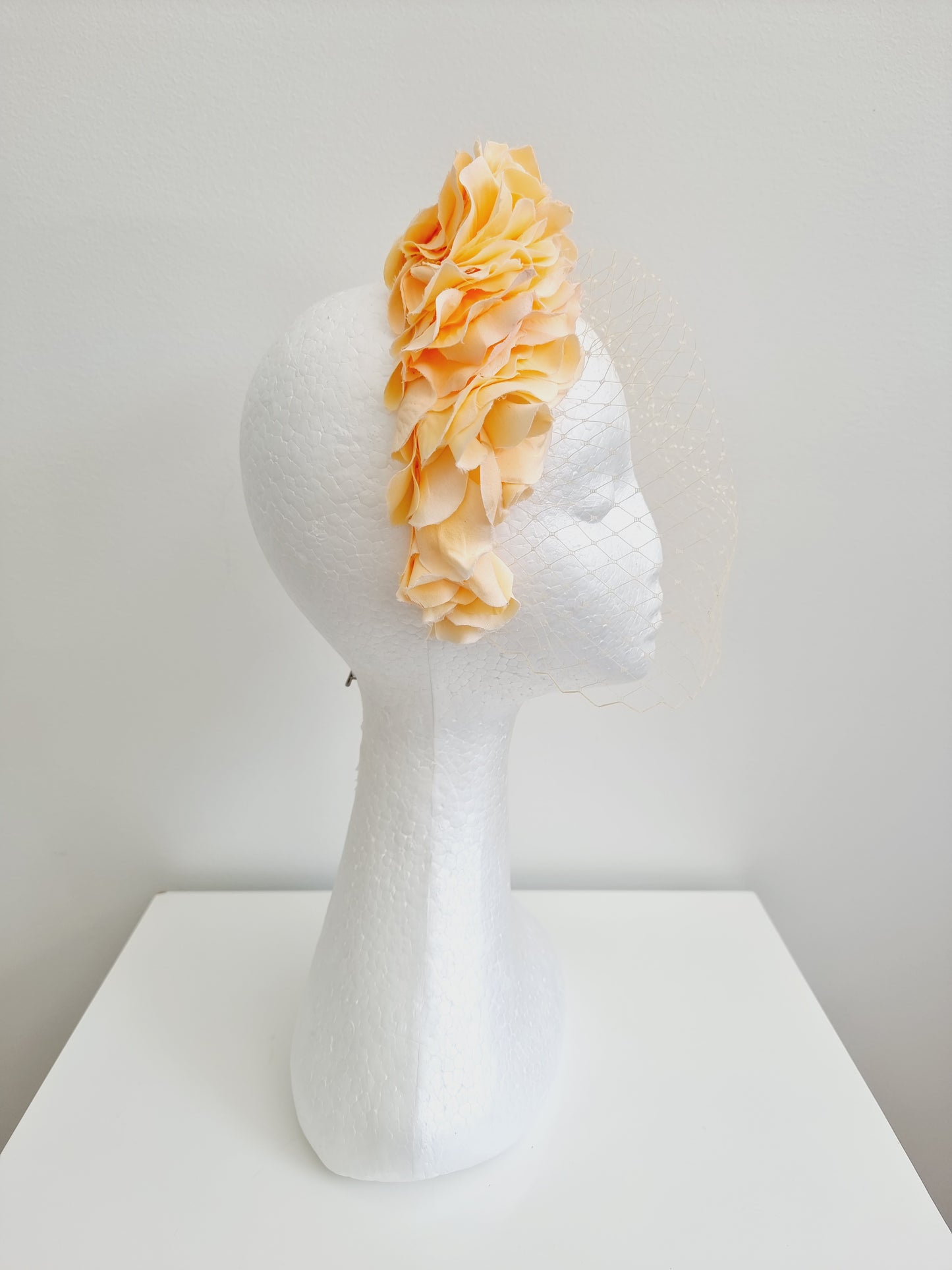 Miss Trixie. Womens ruffle embellished headband with veiling in Peach