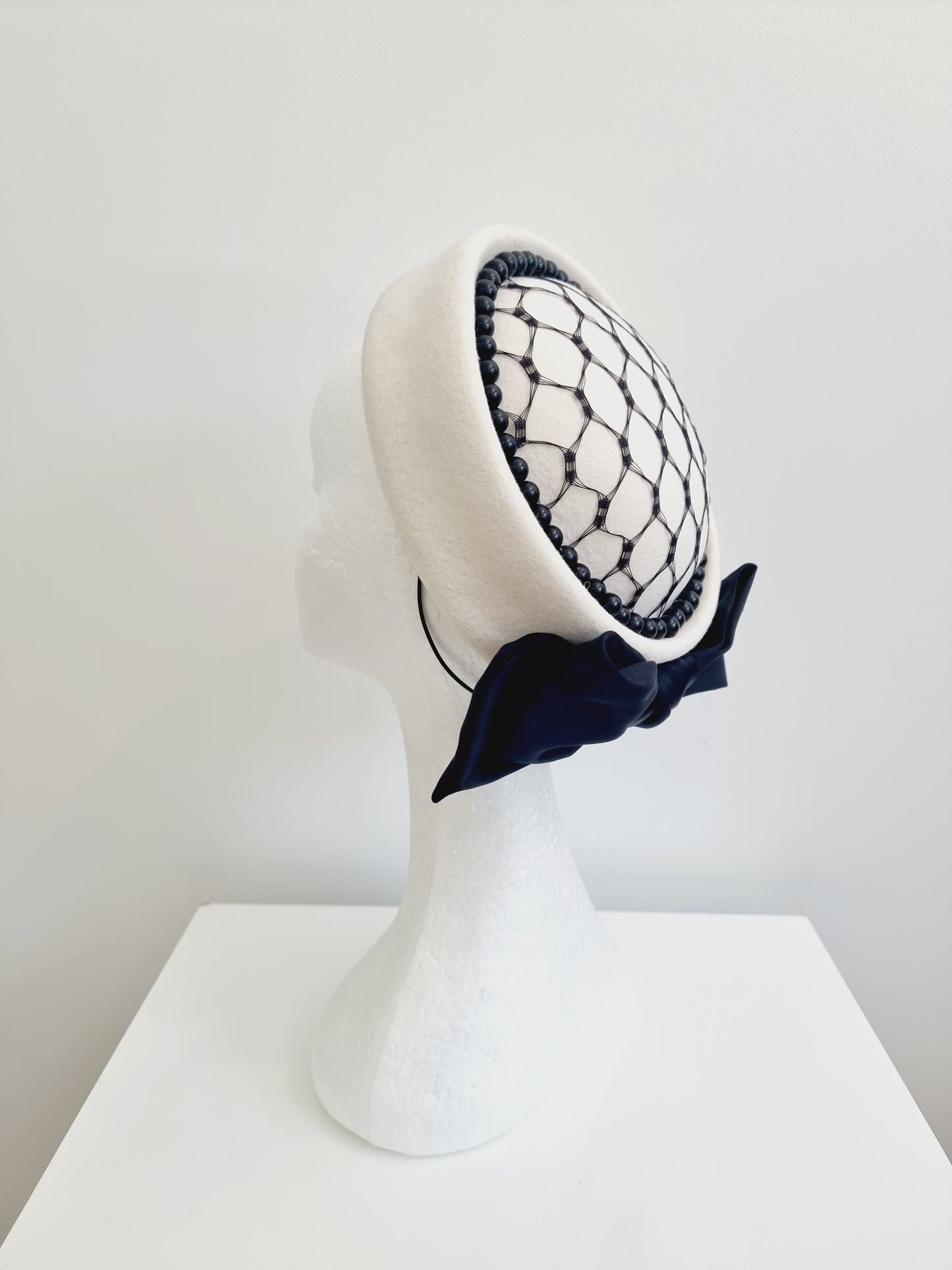 Miss Lavina. Womens Ivory pillbox headpiece with black detailing and bow