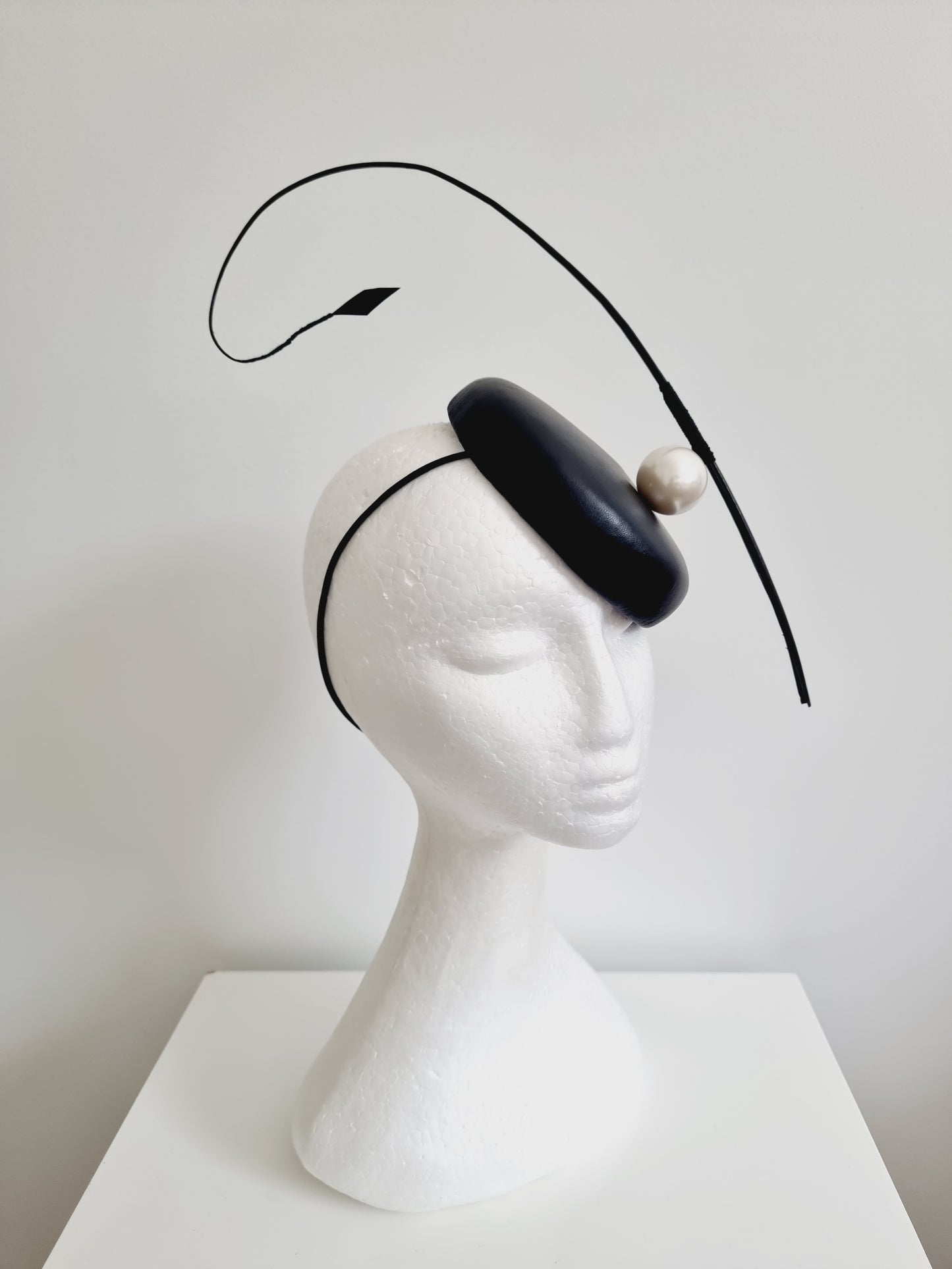 Miss Resolute. Womens Black leather button fascinator with pearl detail