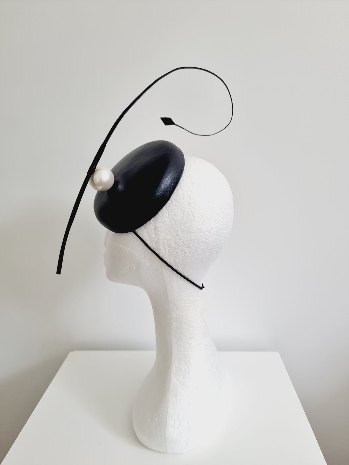 Miss Resolute. Womens Black leather button fascinator with pearl detail