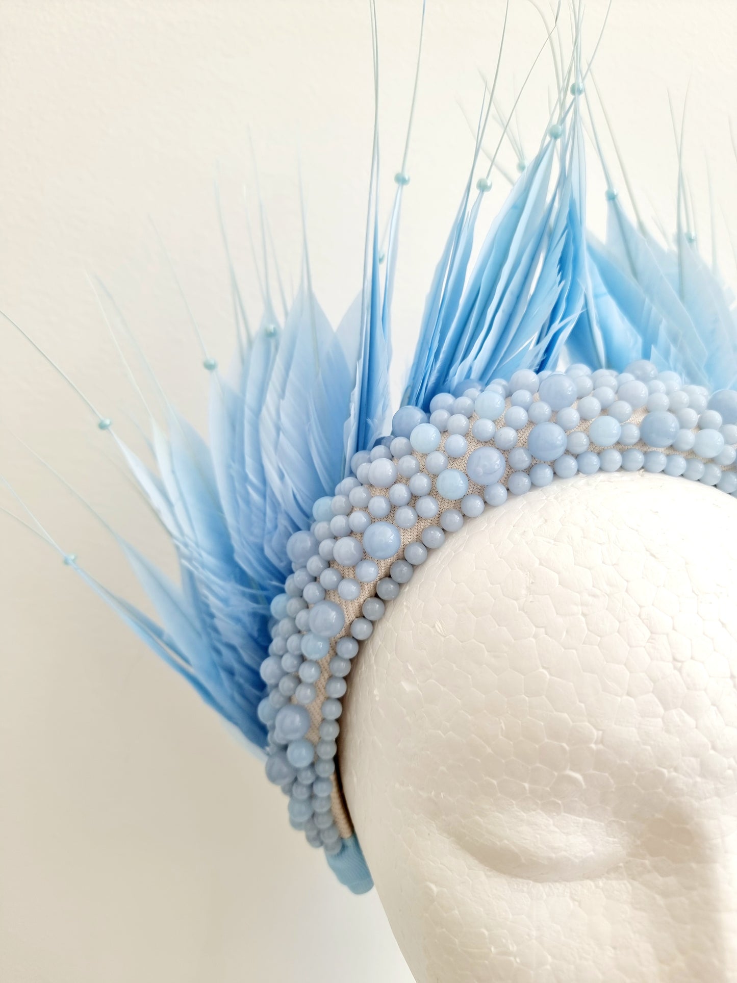 Miss Aldia. Womens Pale Blue pearl and feather headband fasinator