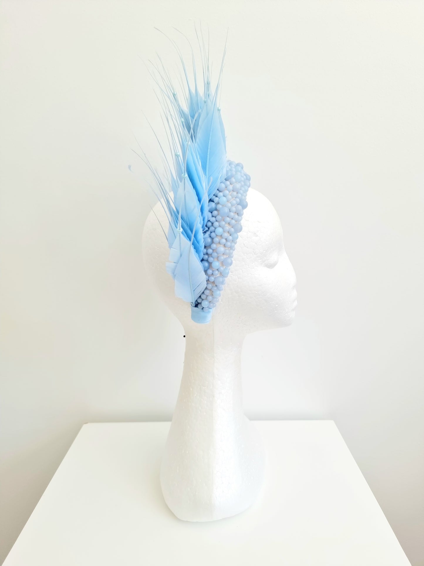 Miss Aldia. Womens Pale Blue pearl and feather headband fasinator