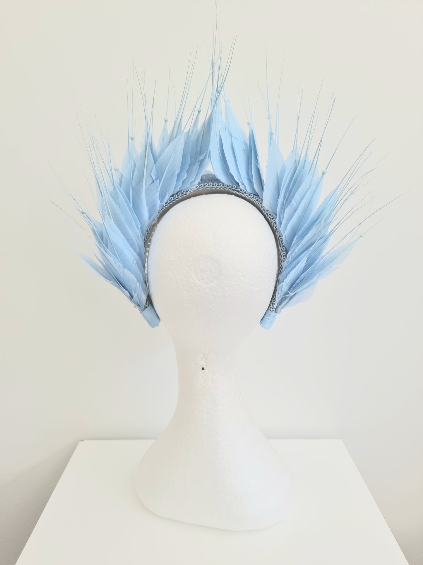 Miss Aldia. Womens Pale Blue pearl and feather headband fasinator