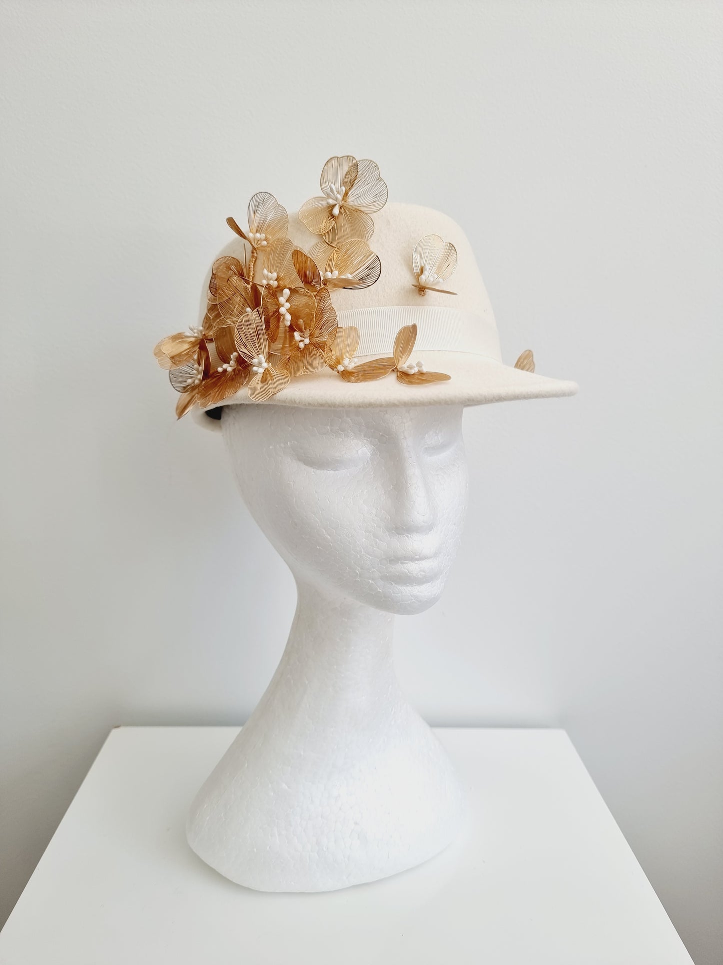 Miss Dominica. Womens Ivory wool felt cap with gold floral  detailing