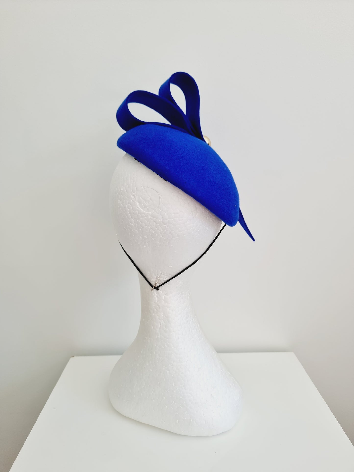 Miss Baker. Womens Royal Blue felt button fascinator with loops