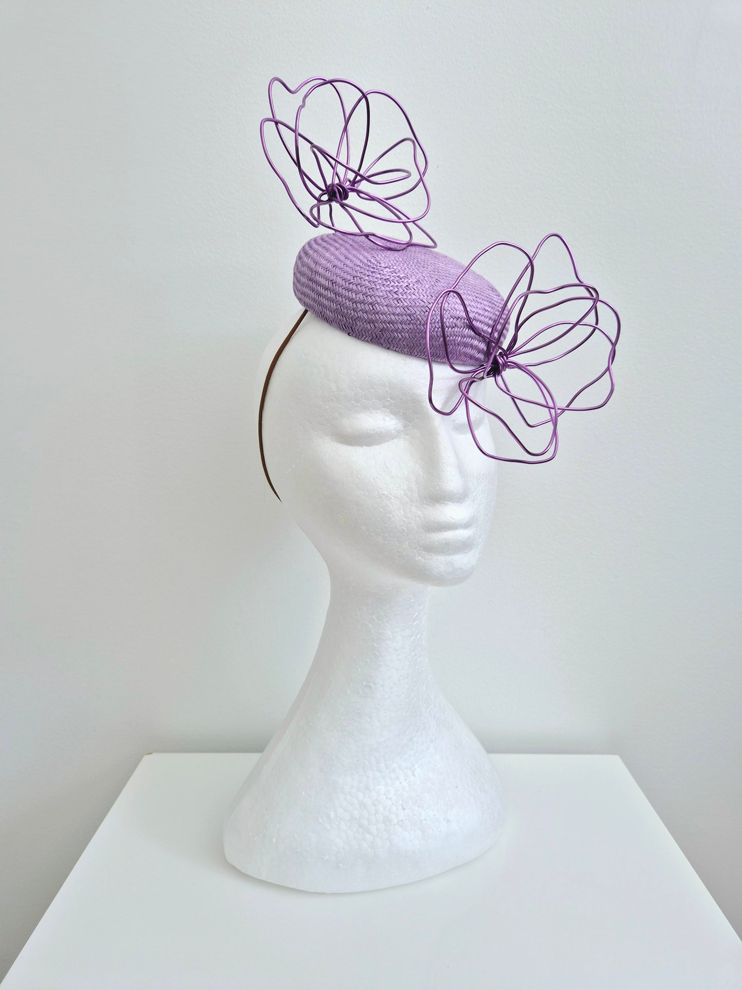 Miss Idalyee.  Womens lilac  button fascinator with purple wire flowers