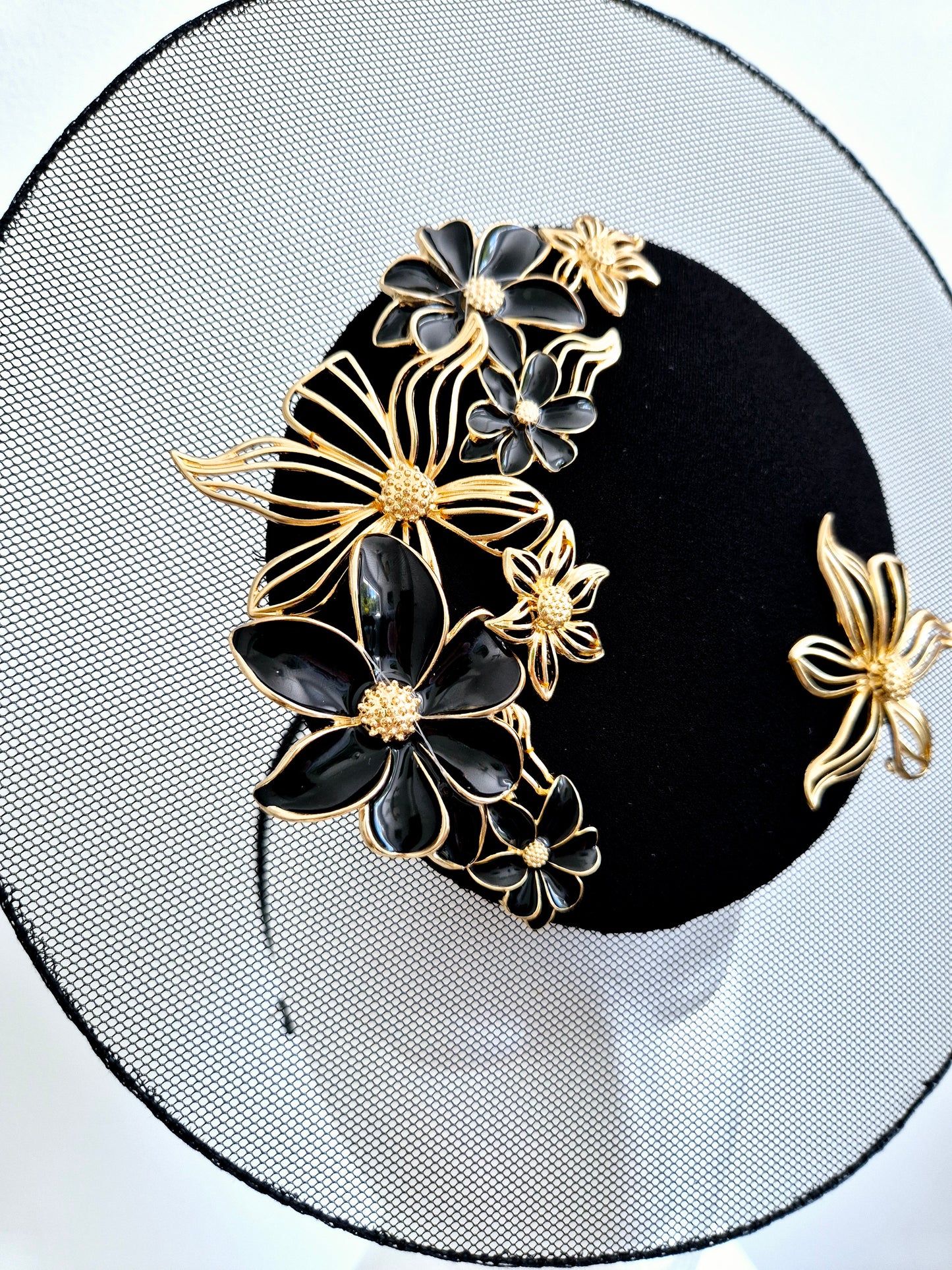 Miss Greta. Womens  Black and gold floral percher fascinator with sheer disk.