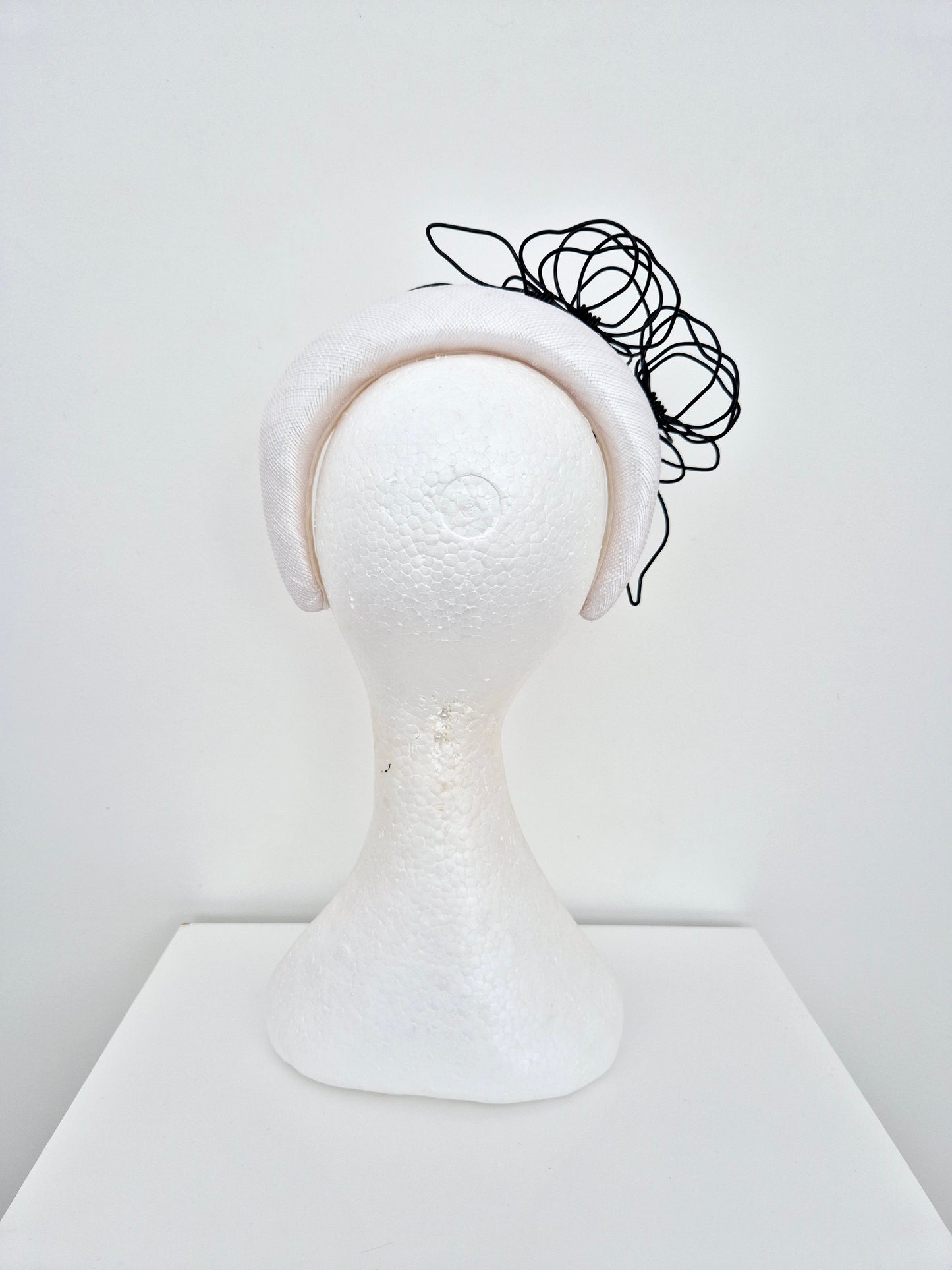 Miss Quinn. Womens White sinamay padded headband with black wire flowers