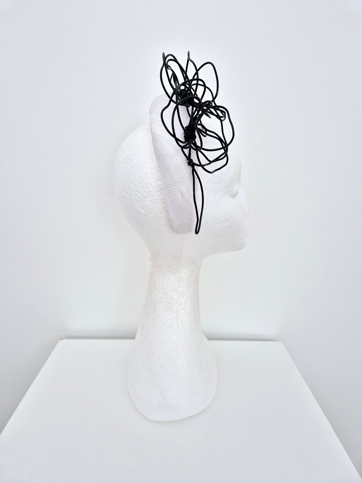 Miss Quinn. Womens White sinamay padded headband with black wire flowers