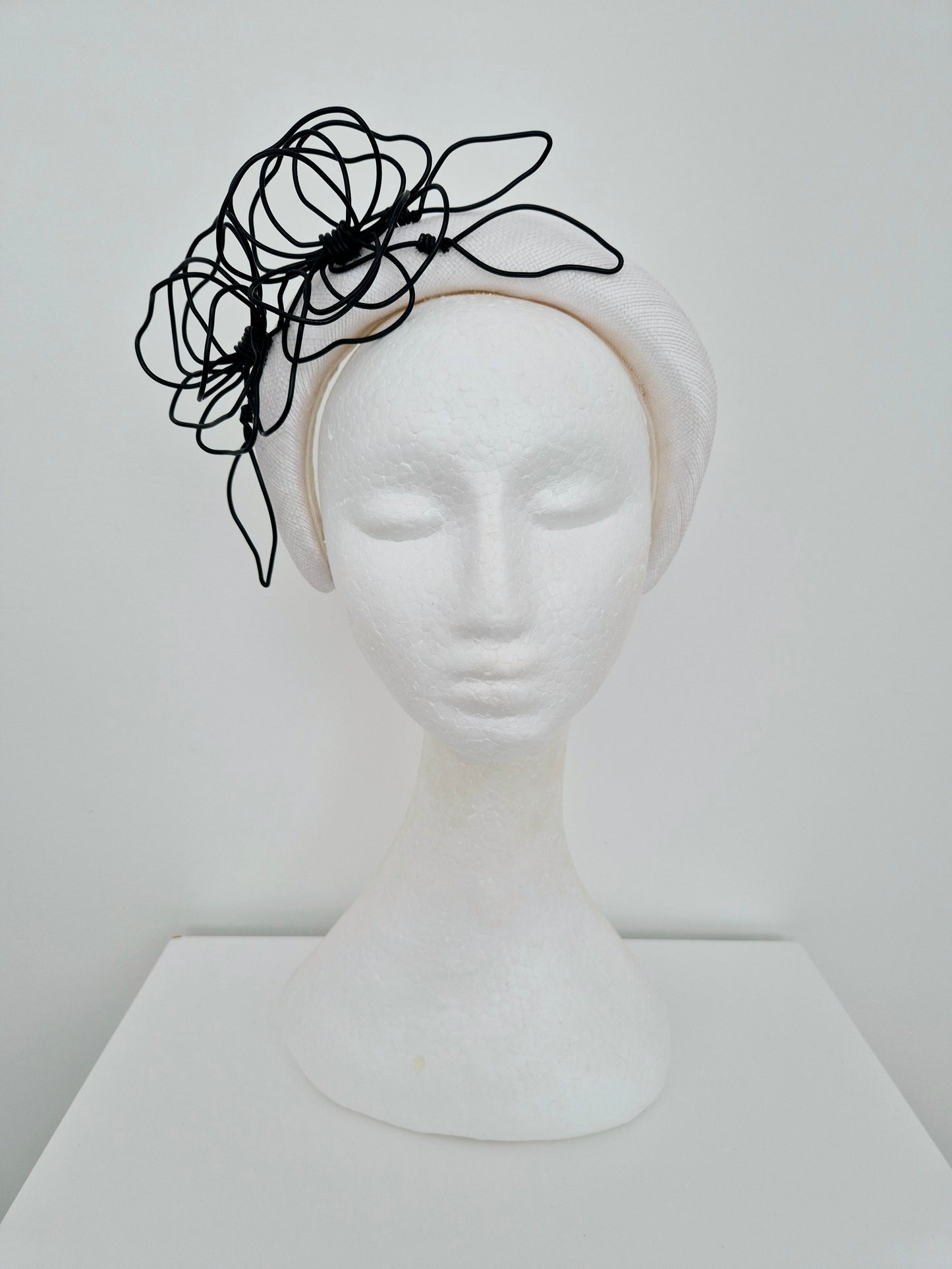 Miss Quinn. Womens White sinamay padded headband with black wire flowers