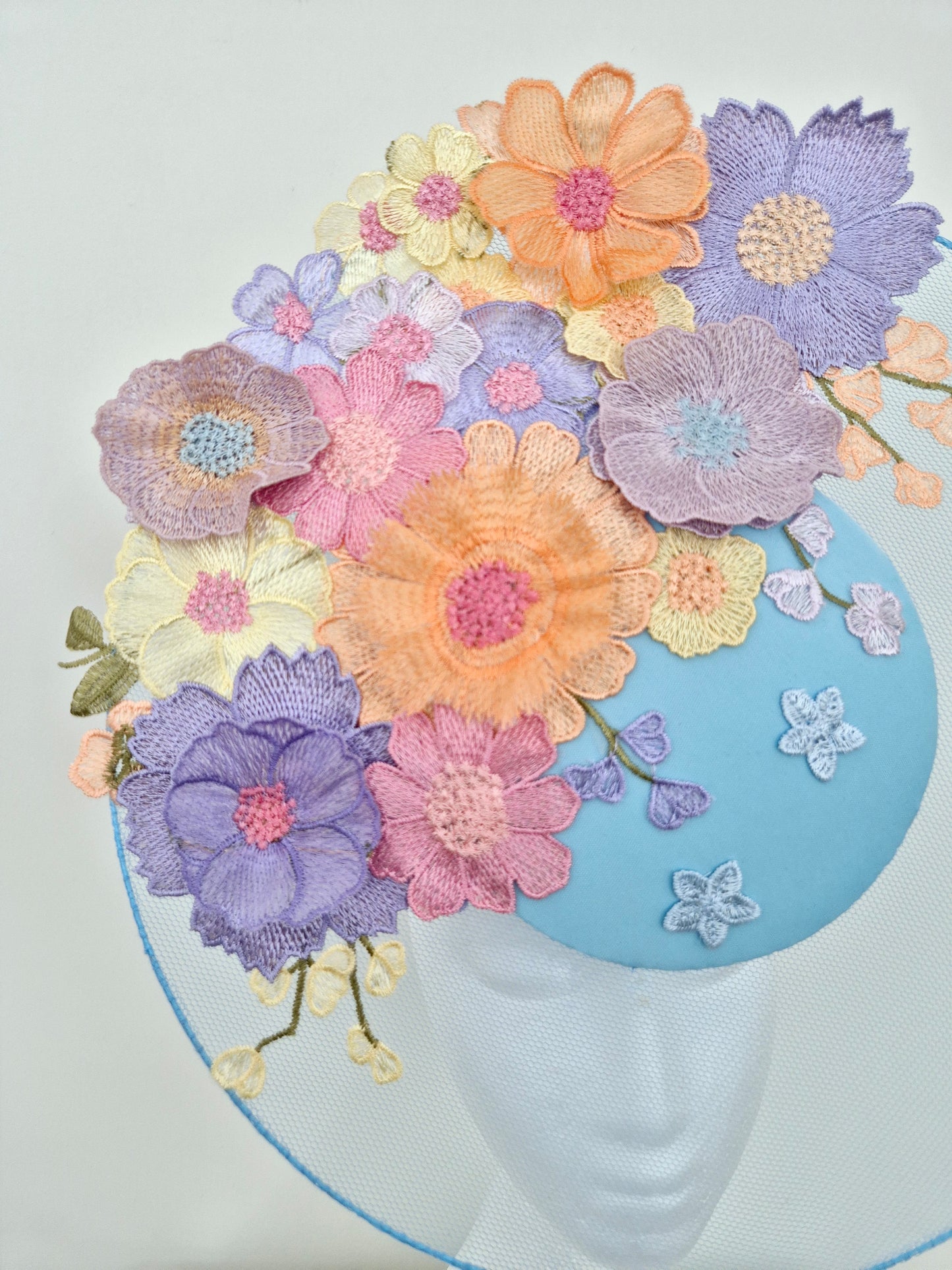 Miss Whimsical. Womens Light Blue satellite percher headband fascinator with pastel multi 3D flowers