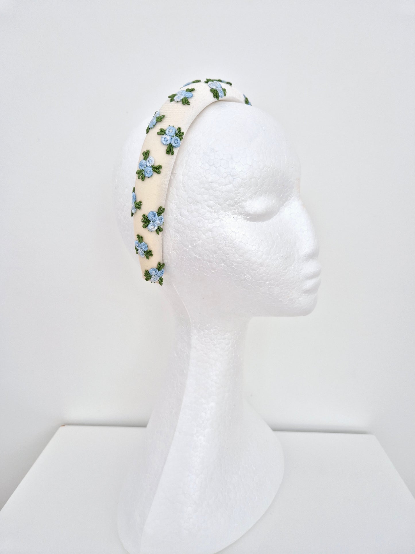 Miss Melinda. Womens ivory velvet headband adorned with embroidered rose buds in Blue tones