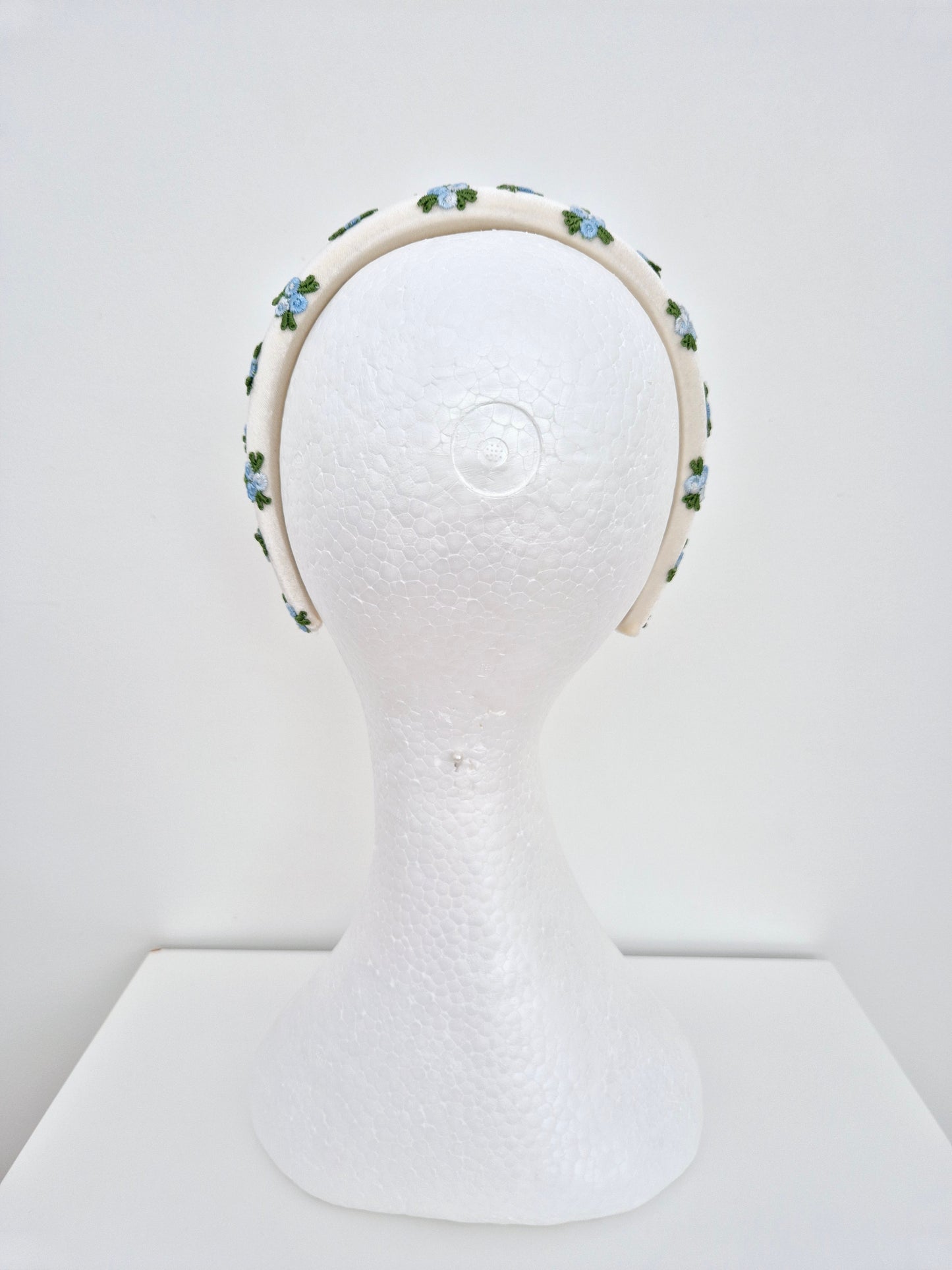 Miss Melinda. Womens ivory velvet headband adorned with embroidered rose buds in Blue tones