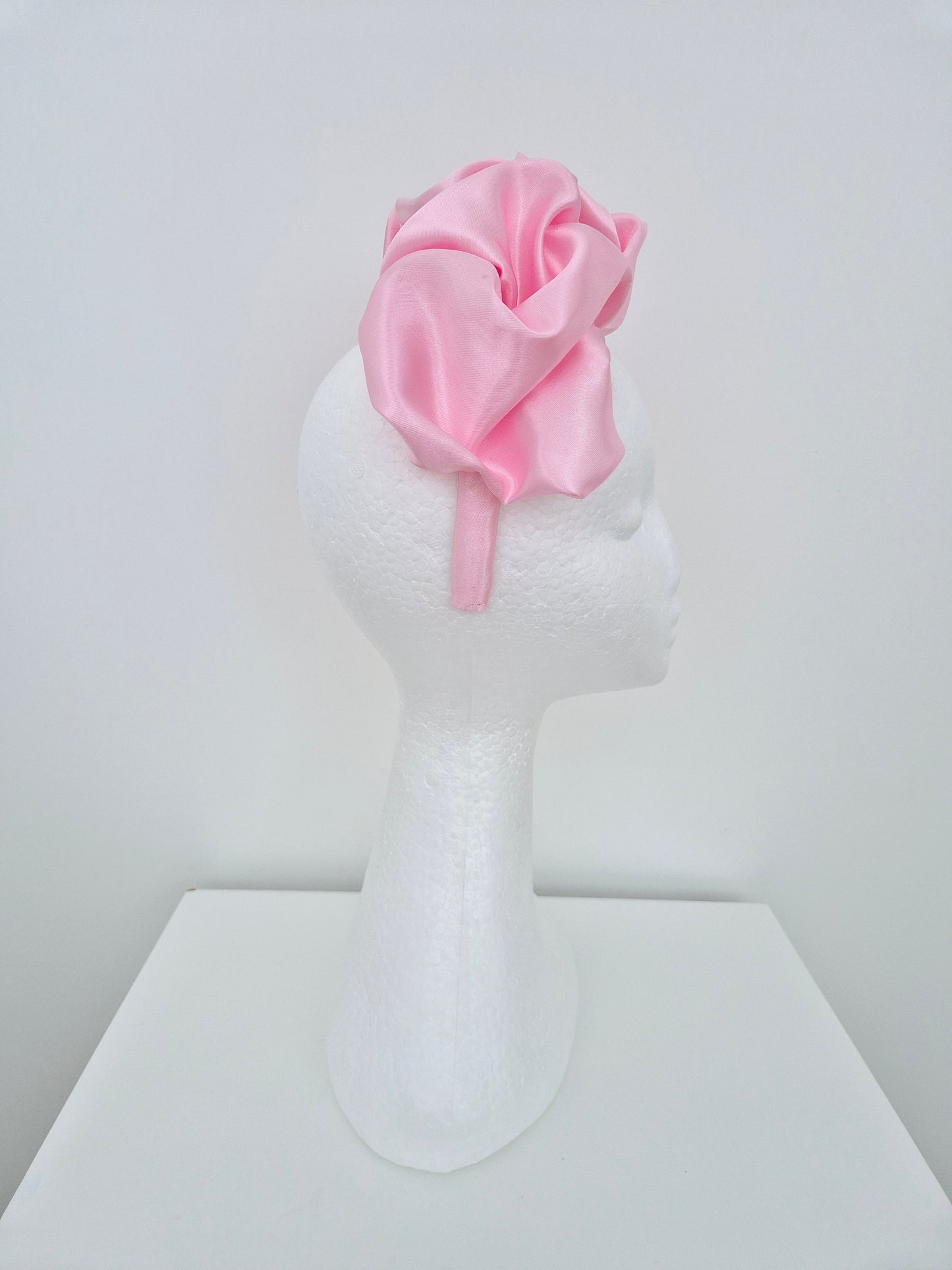 Miss Lauren. Womens satin scrunch headband fascinator in Pink icing