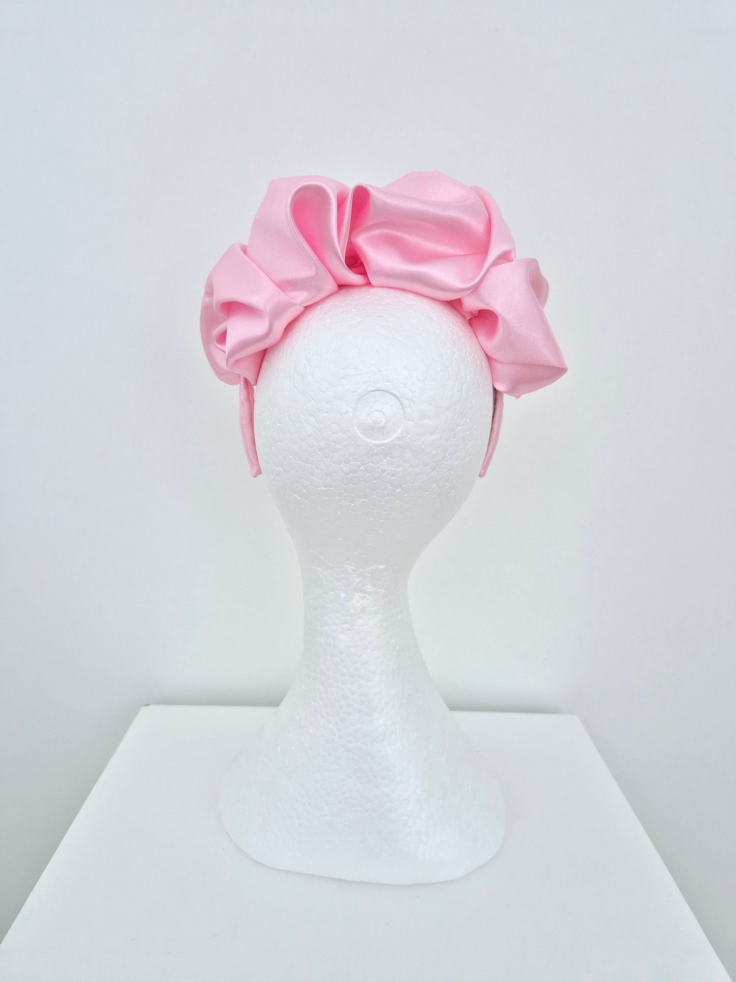 Miss Lauren. Womens satin scrunch headband fascinator in Pink icing