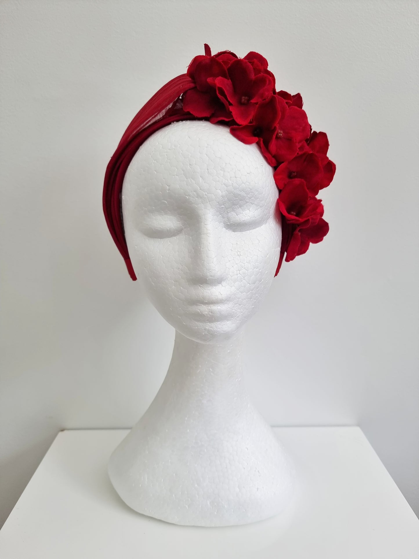 Miss Lucille. Womens deep red silk twist top headband with flower detail