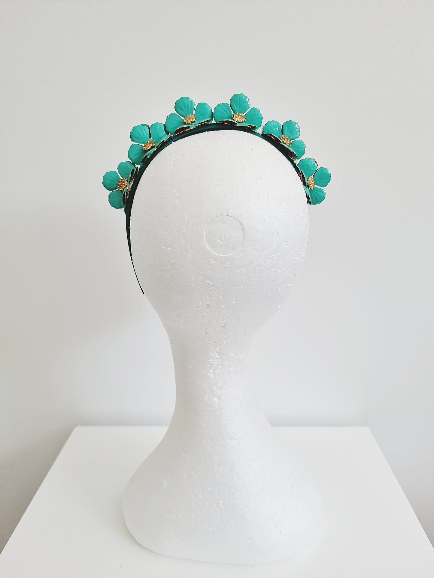 Miss Keeta. Womens metal flower embellished headband in Jade green /gold