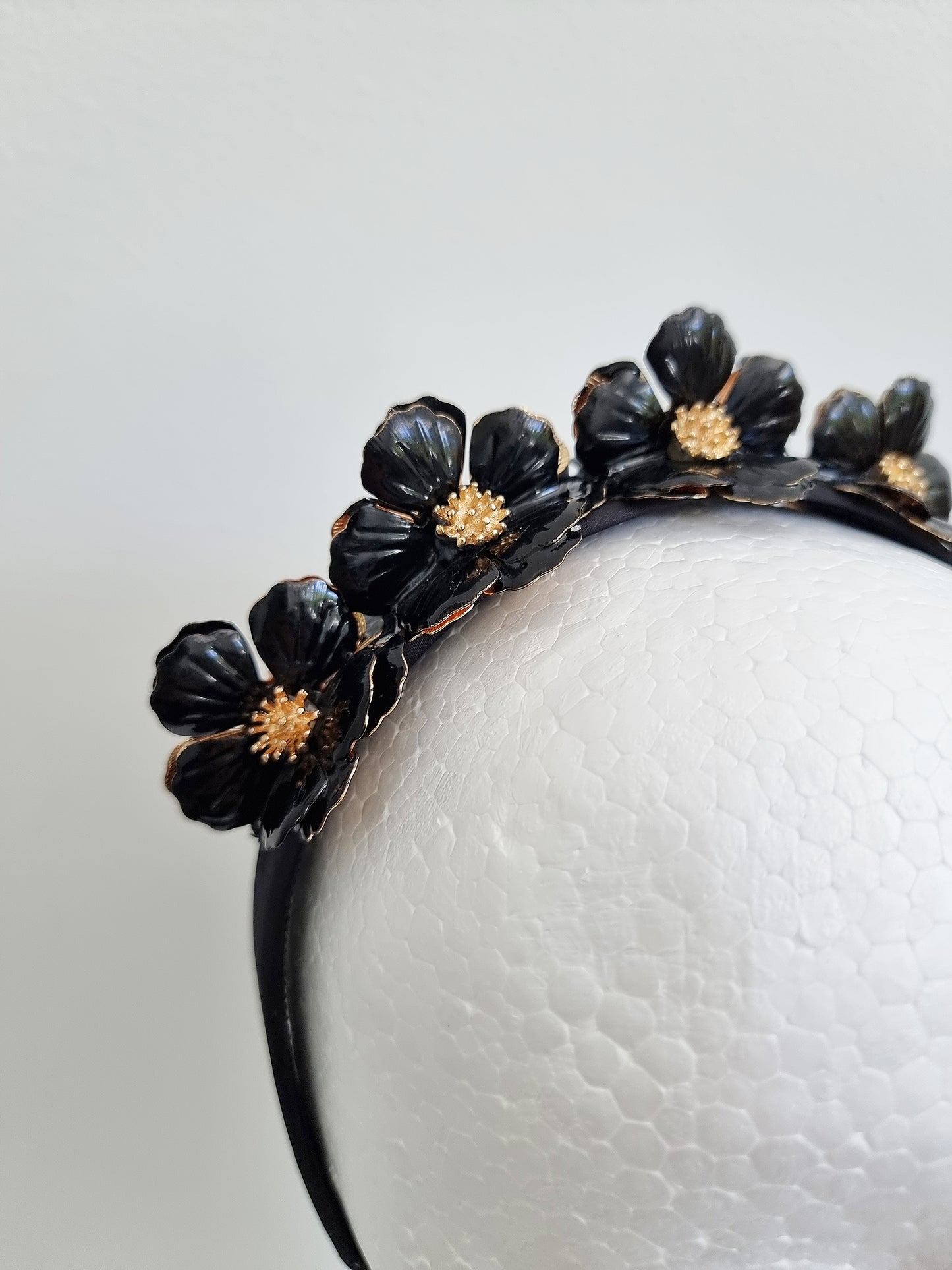 Miss Keeta. Womens metal flower embellished headband in black /gold