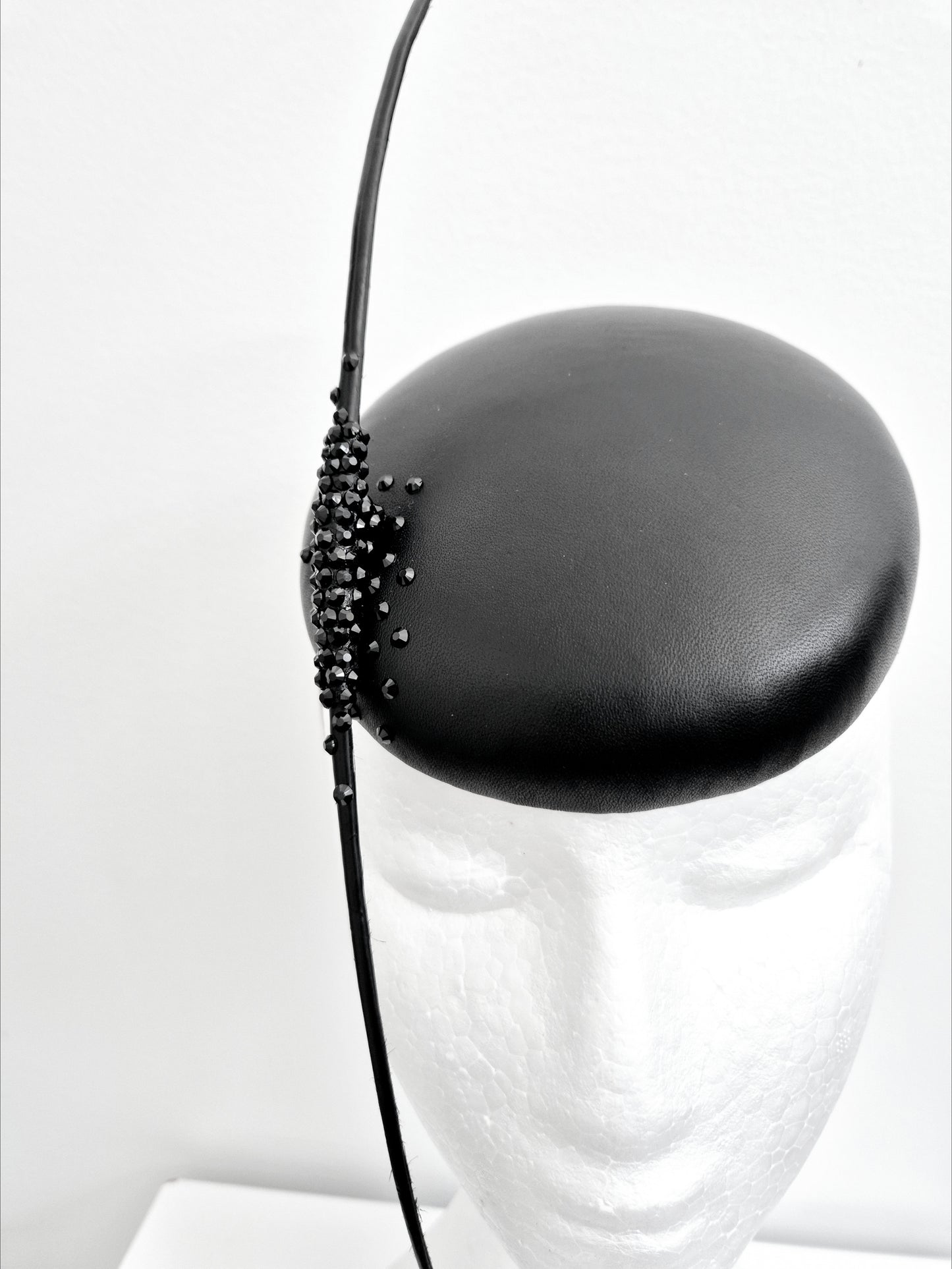 Miss On the Dot.  Womens Black leather button fascinator with quills and rhinestones