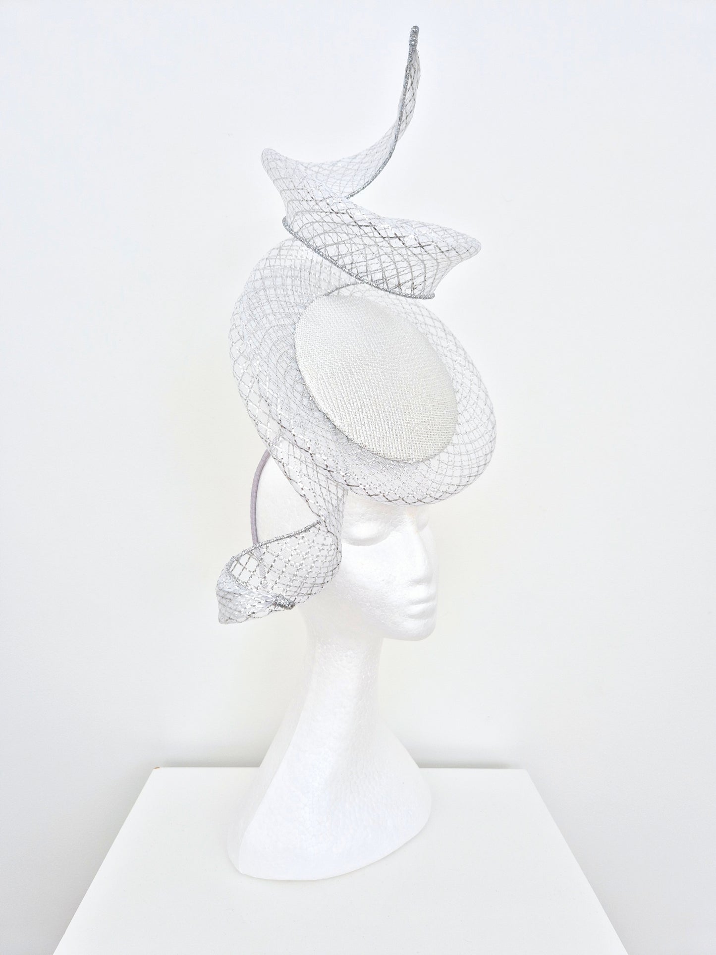 Miss Duke. Womens Silver button percher headband fascinator with crinoline swirl