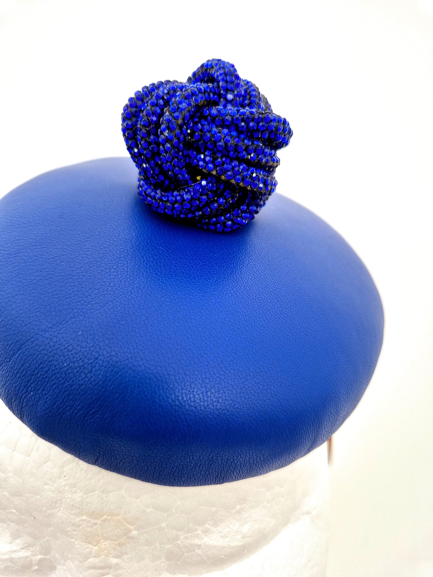 Miss Fia. Womens Royal Blue leather button fascinator with rhinestone knotted ball