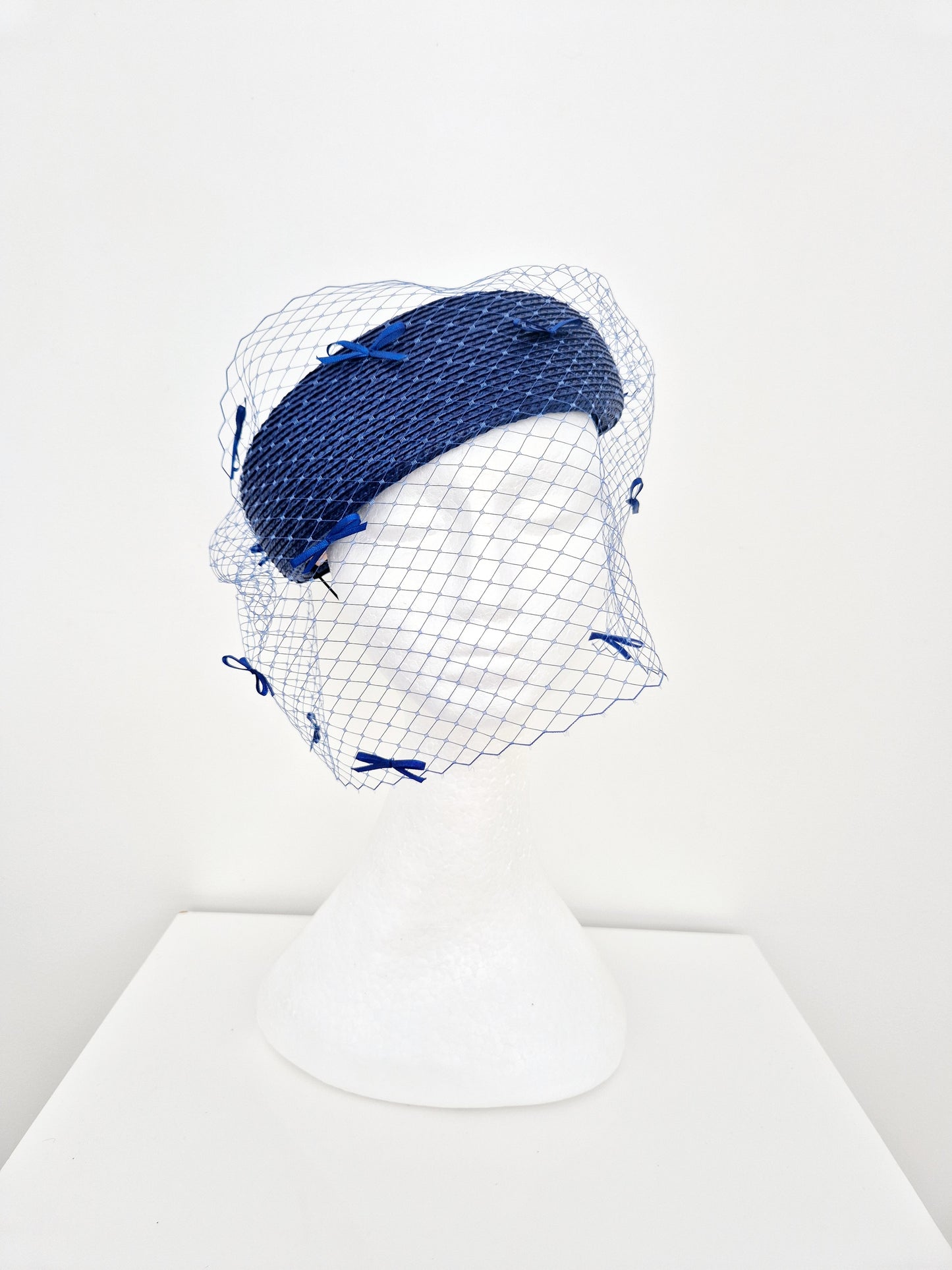 Miss Bella. Womens Royal Blue headpiece with veiling and bows