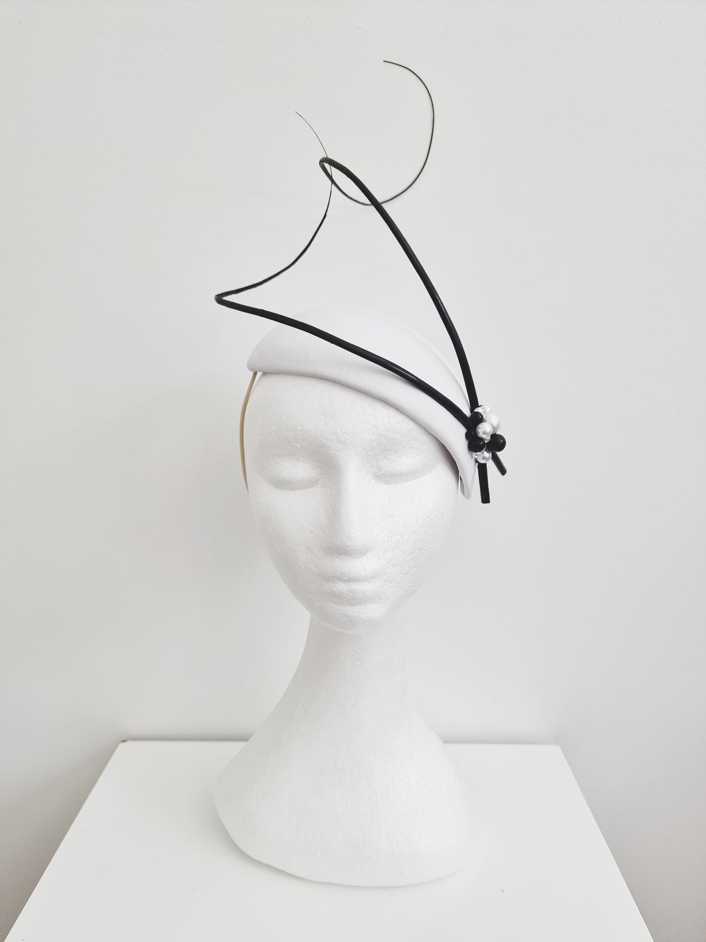 Miss Chantelle. Womens black and white fascinator with pearl detail